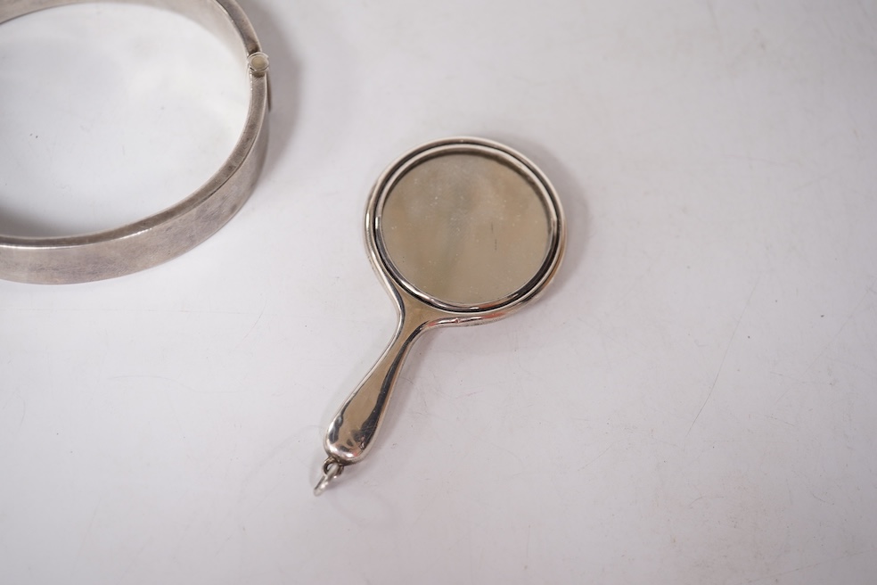 A late Victorian white metal and Scottish hardstone set 'X' brooch with coronet, 34mm, together with a silver hinged bangle and a George V silver mounted handbag mirror, with Reynold's Angels decoration. Condition - poor
